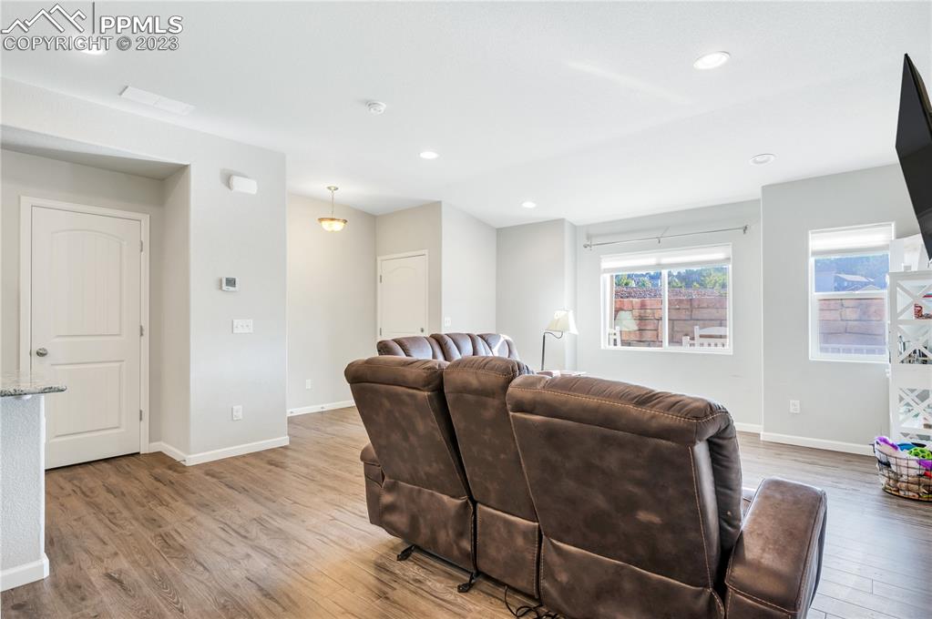 2118 Birmingham Loop Colorado Springs, CO 80910 - Photo 5 of 28 a living room with furniture and wooden floor