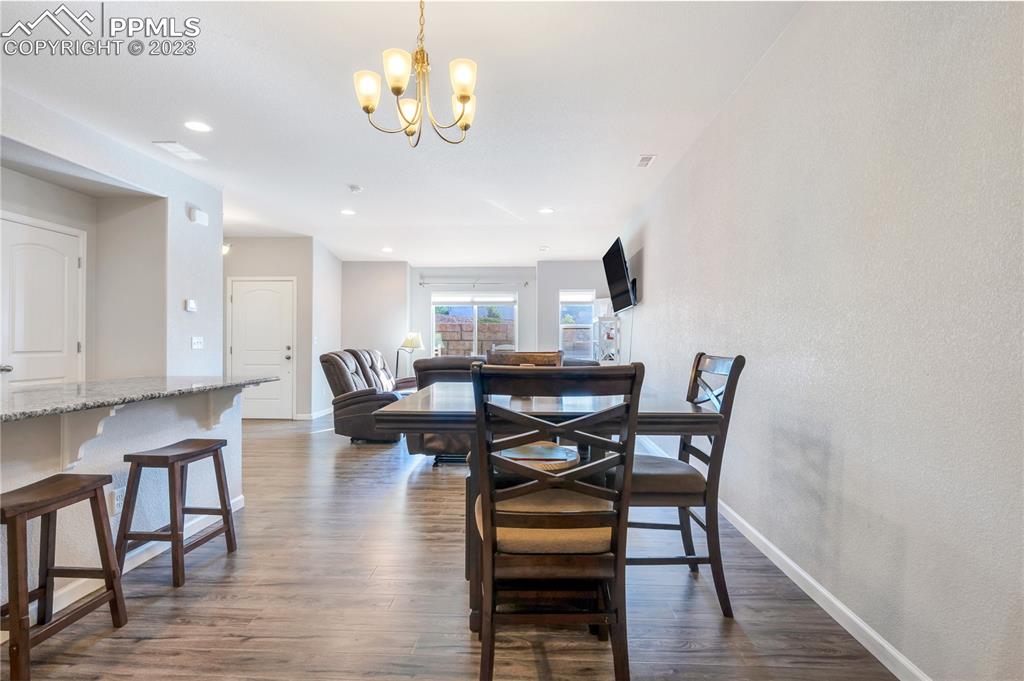 2118 Birmingham Loop Colorado Springs, CO 80910 - Photo 9 of 28 a view of a dining room with furniture and wooden floor