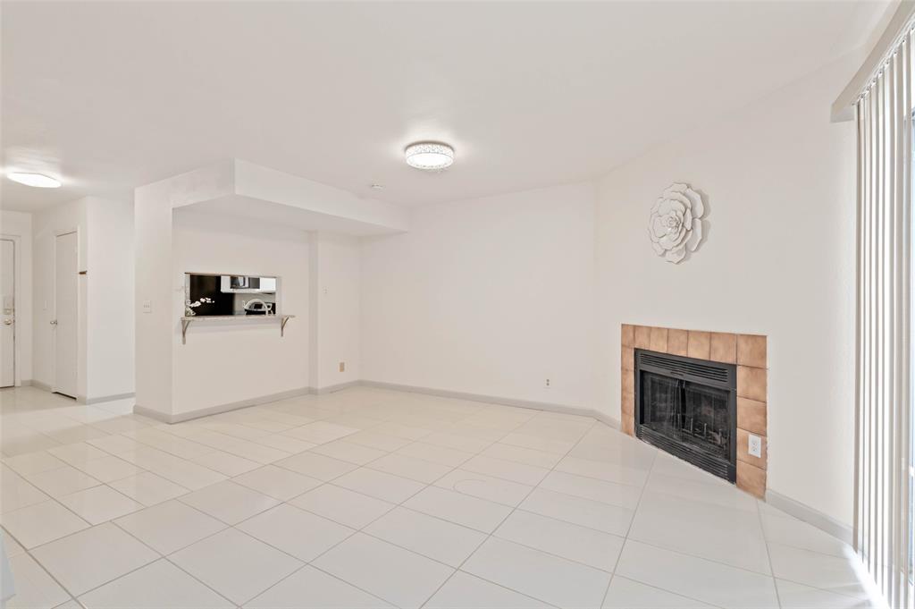 700 West Collins Street Denton, TX 76201 - Photo 13 of 36 Large living room with fireplace and patio access
