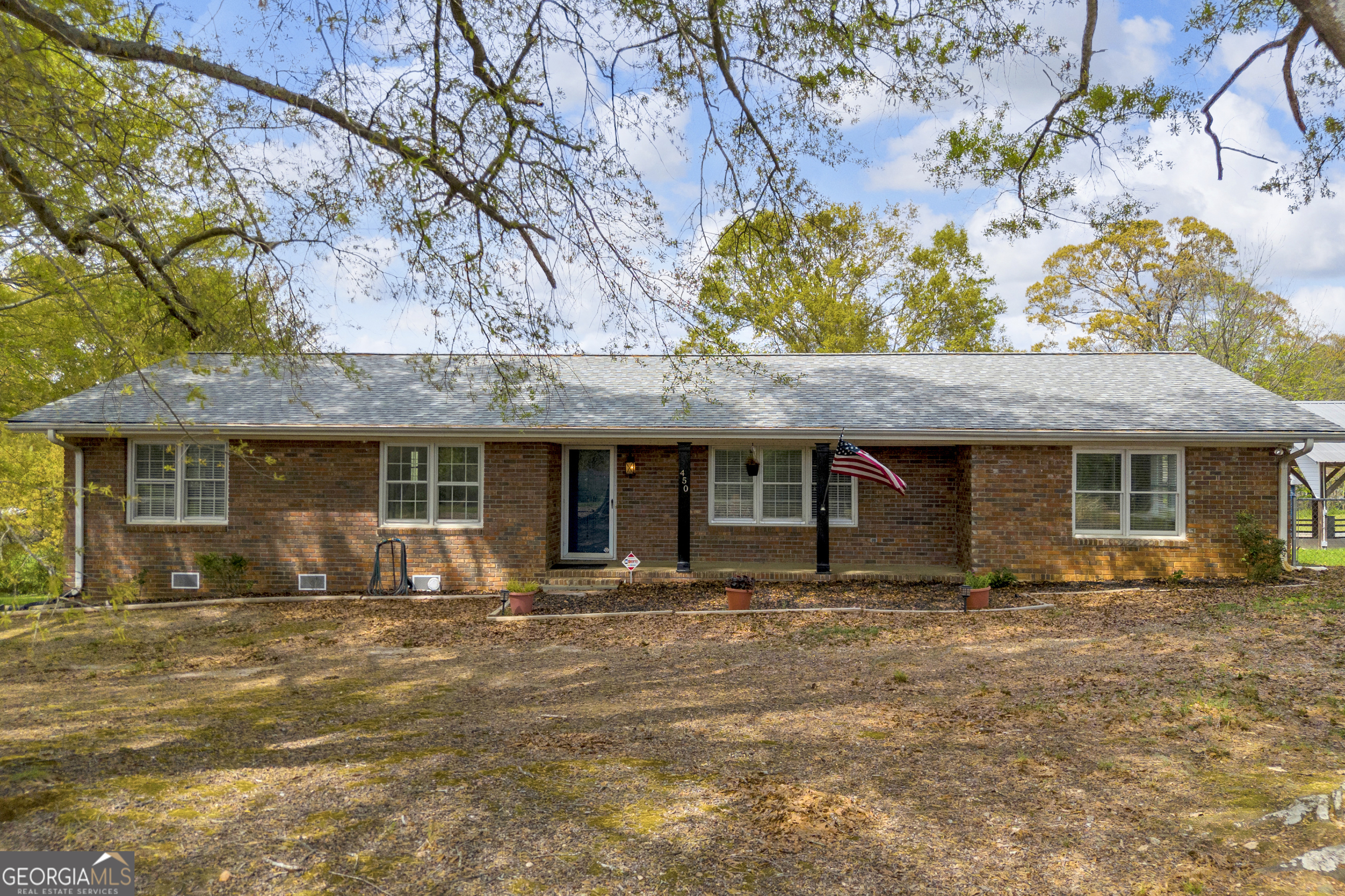 a front view of a house with a garden
