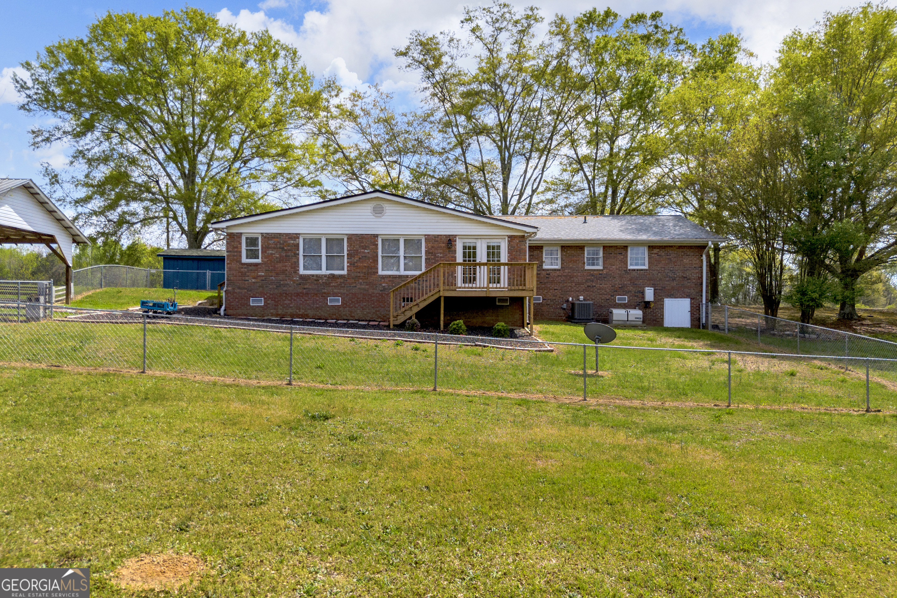 450 Clarks Creek Road North Martin, GA 30557 - Photo 17 of 70 a front view of a house with a yard table and chairs