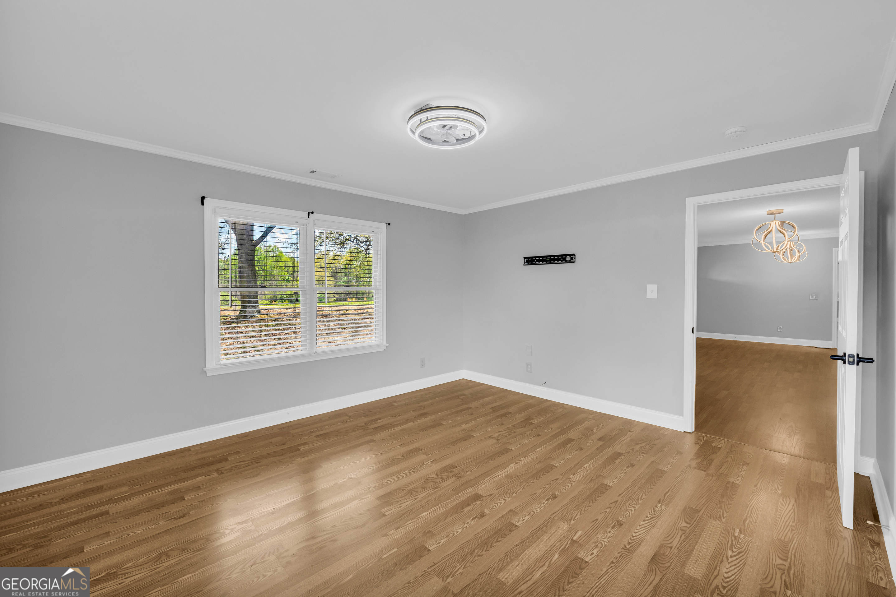 450 Clarks Creek Road North Martin, GA 30557 - Photo 29 of 70 an empty room with window and wooden floor