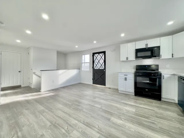 a large bedroom with a bed and a television