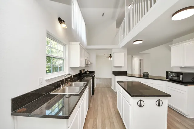a kitchen with a stove a sink and a refrigerator