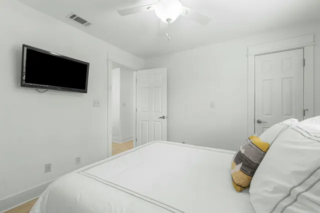 a bedroom with a bed and a flat screen tv
