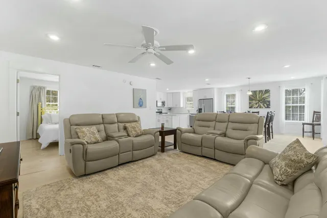 a living room with furniture and a ceiling fan