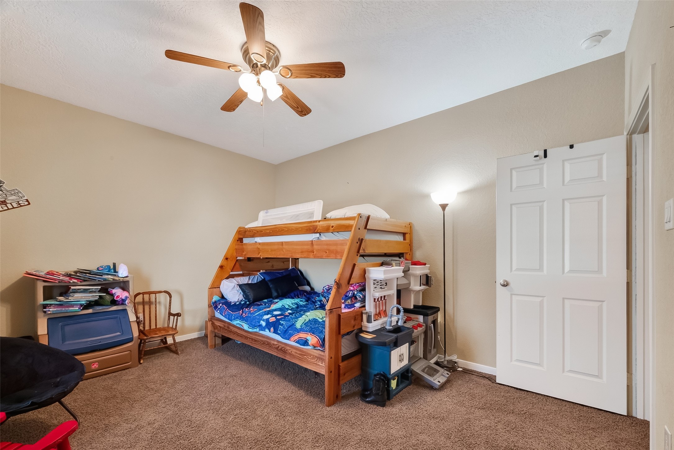 3418 Barbers Hill Road Highlands, TX 77562 - Photo 39 of 50 a bedroom with bed and a chandelier