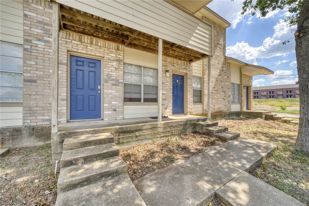 910 Spring Loop, Unit B College Station, TX 77840 - Photo 2 of 10 Entrance to property with a porch and brick siding