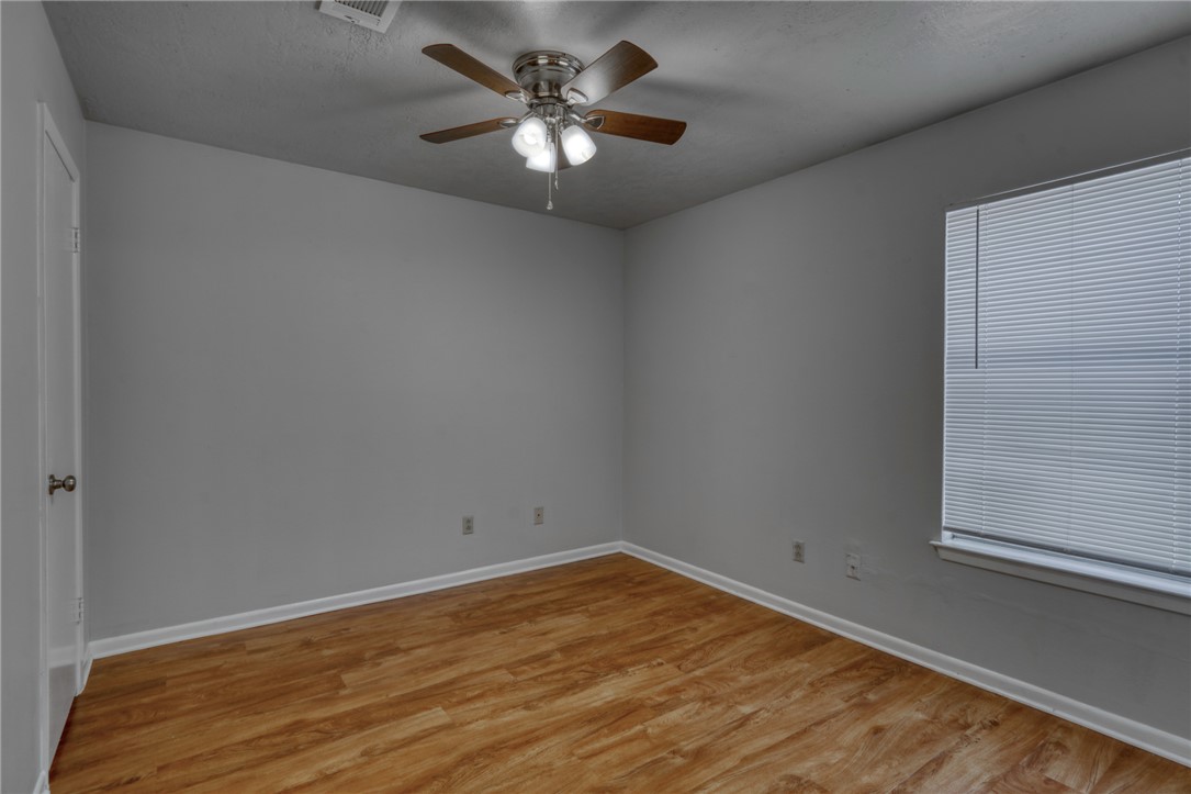 910 Spring Loop, Unit B College Station, TX 77840 - Photo 9 of 10 Unfurnished room with light wood-style floors and ceiling fan