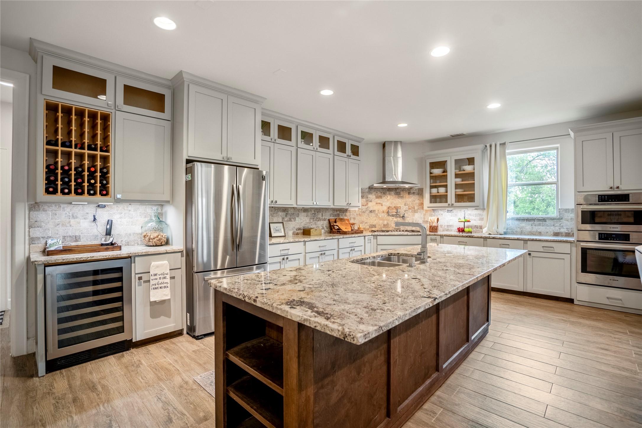 3202 Ozark Street Houston, TX 77021 - Photo 9 of 31 Chef's kitchen is equipped with a rich stained island, granite countertops, under cabinet lighting, wine storage and wine refrigerator.