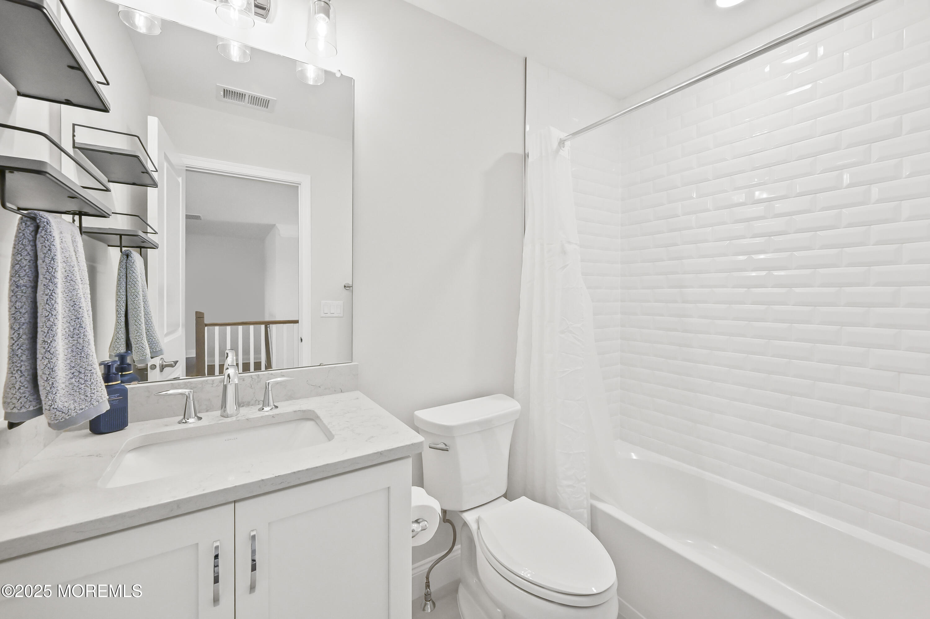 60 Sofia Drive Manalapan, NJ 07726 - Photo 18 of 25 a bathroom with a sink a toilet and shower