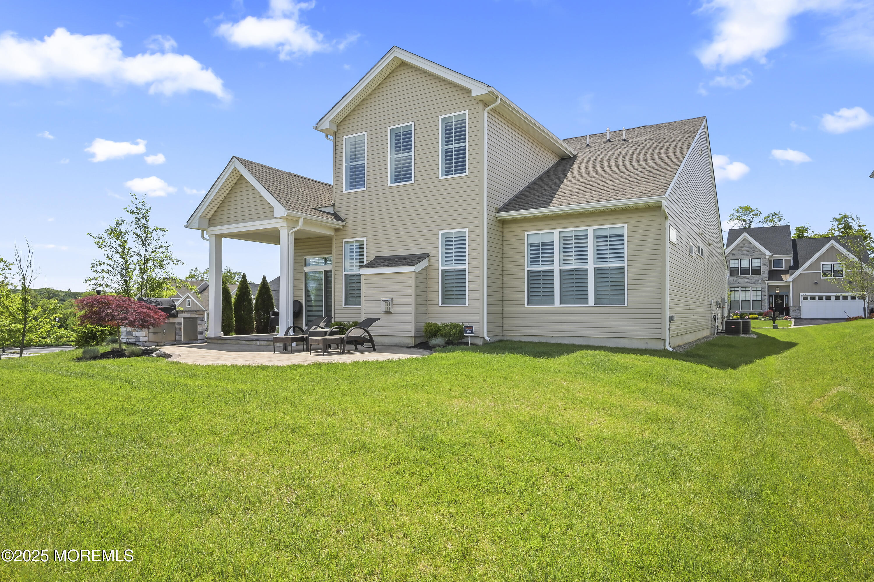 60 Sofia Drive Manalapan, NJ 07726 - Photo 22 of 25 a view of a house with backyard and sitting area