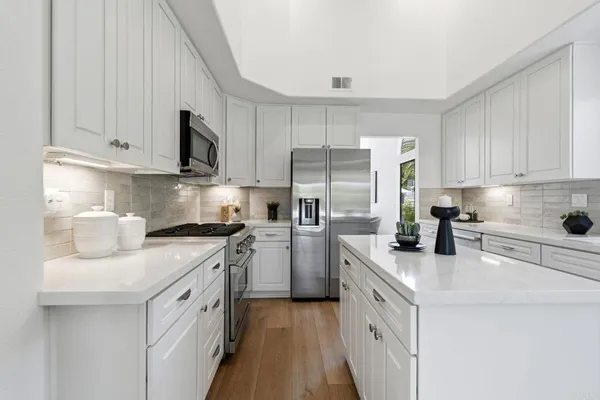 a bathroom with double vanity sinks and a mirror