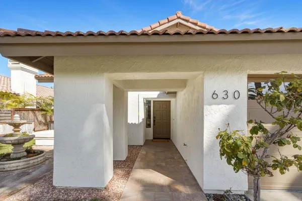 a view of a patio with table and chairs and potted plants