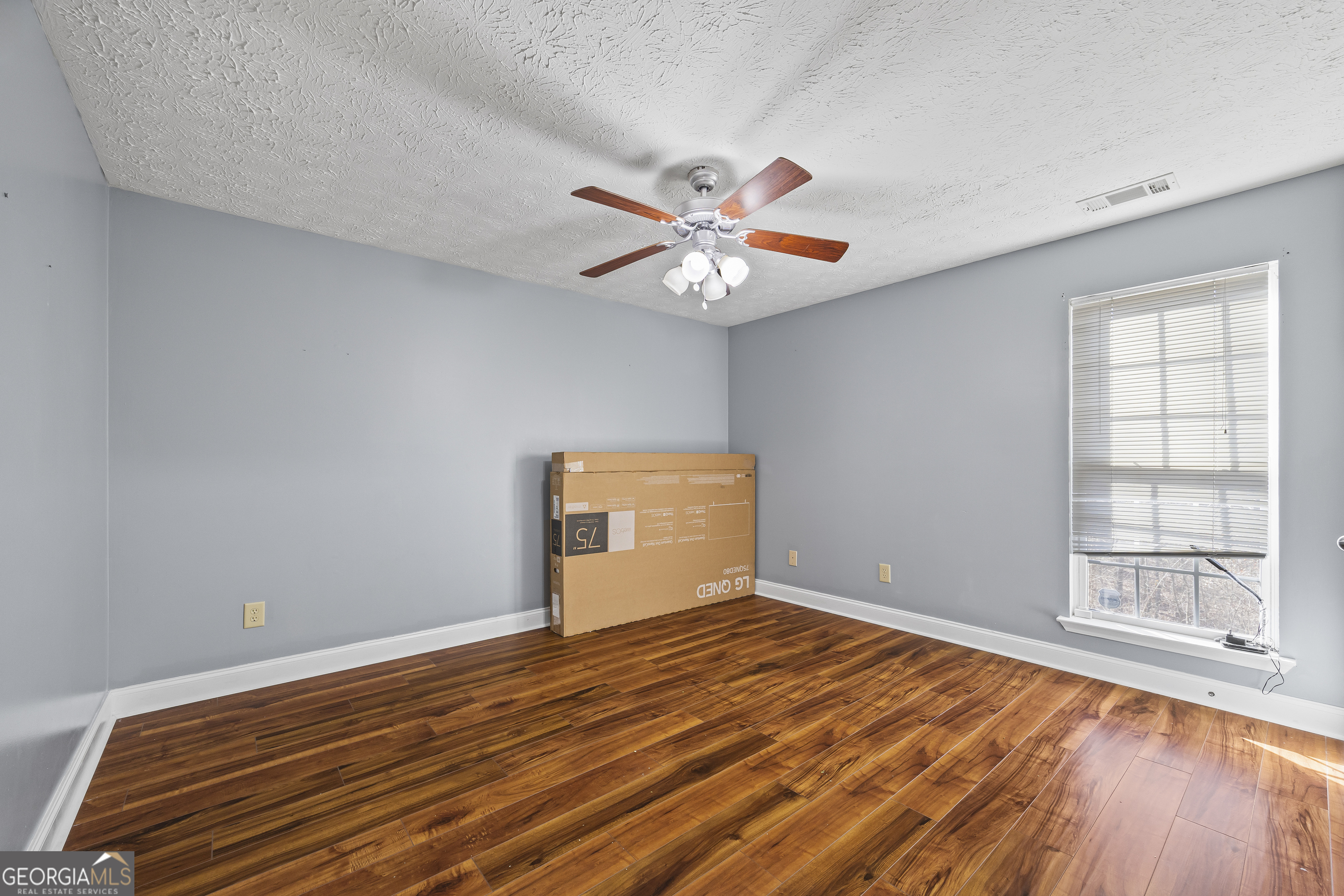747 Washington Road Lexington, GA 30648 - Photo 108 of 118 a view of an empty room with window and wooden floor