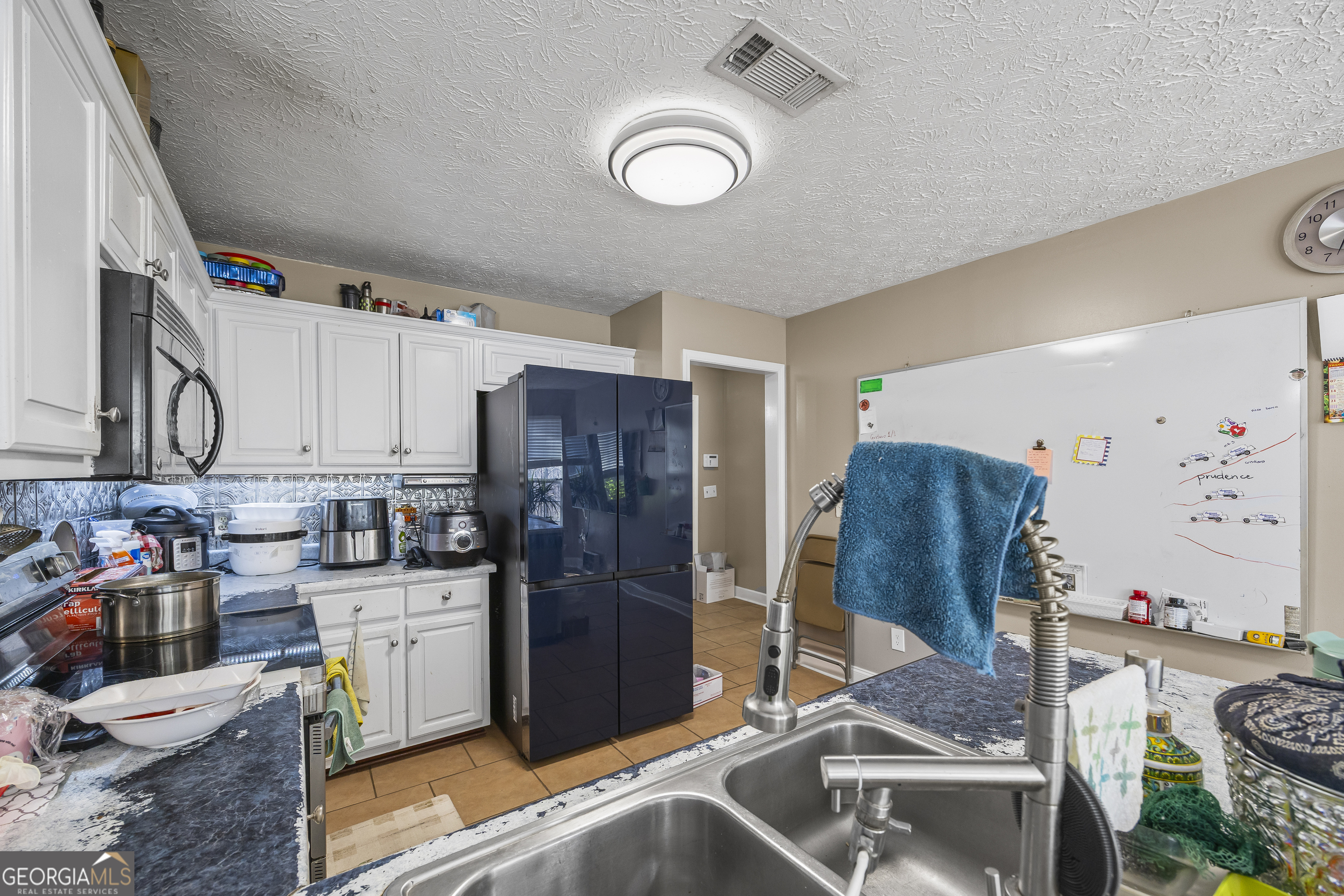 747 Washington Road Lexington, GA 30648 - Photo 114 of 118 a kitchen with stainless steel appliances granite countertop a refrigerator and a stove top oven