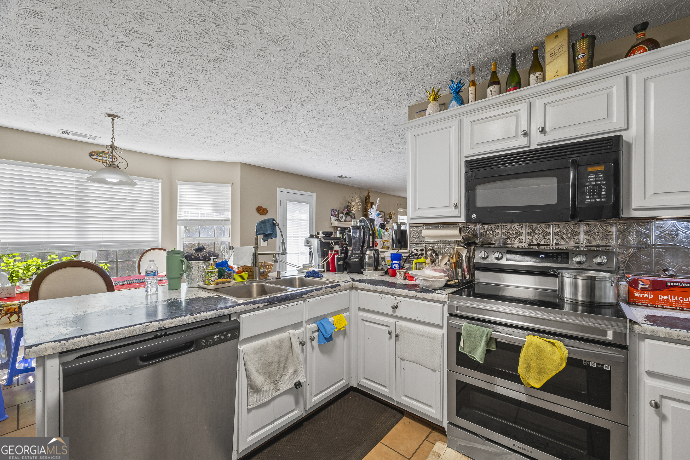 747 Washington Road Lexington, GA 30648 - Photo 115 of 118 a kitchen with stainless steel appliances granite countertop a stove and cabinets