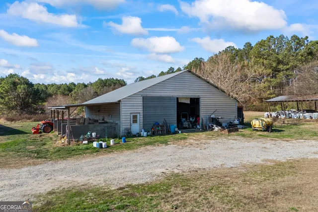 a view of a dry yard with wooden fence