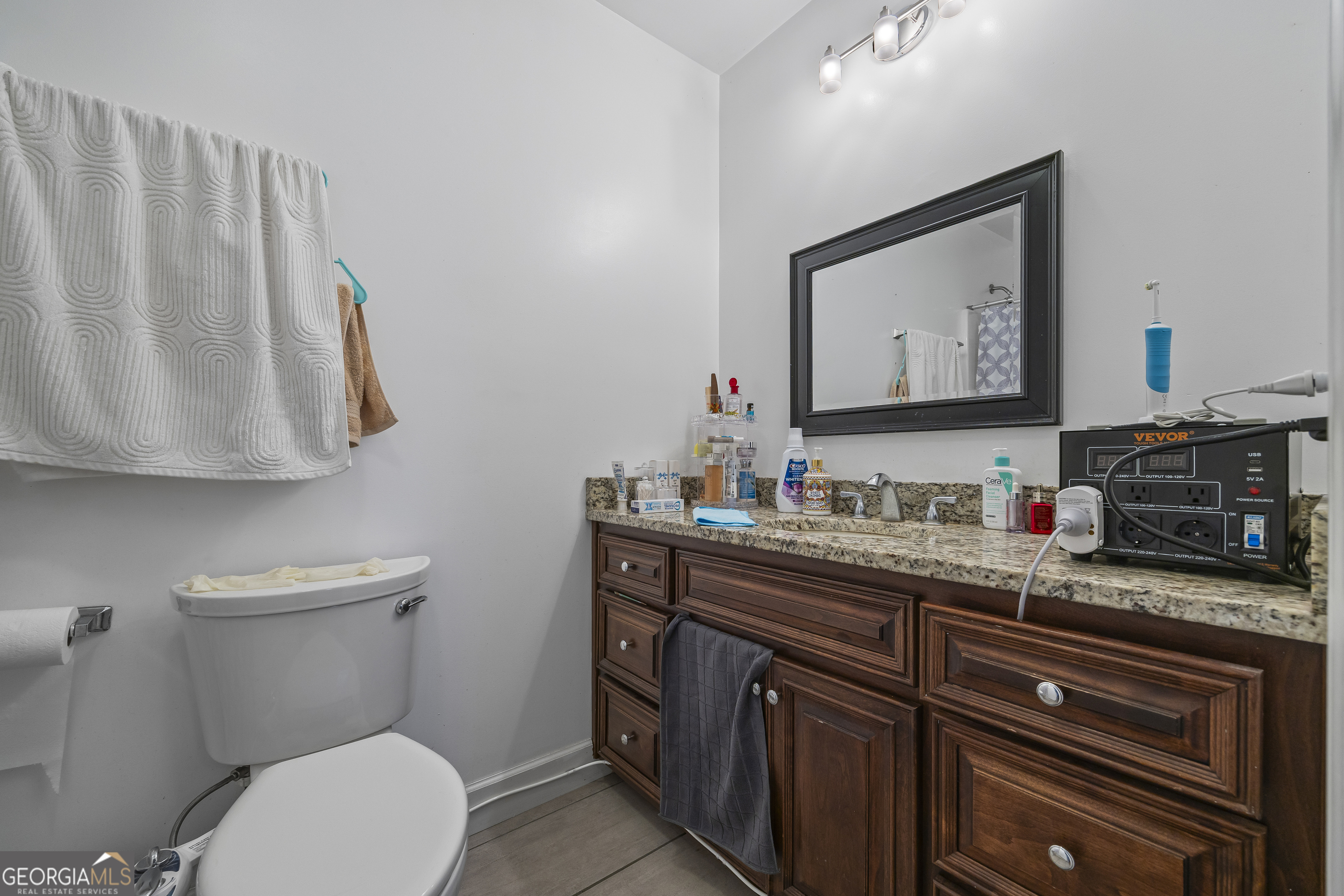 747 Washington Road Lexington, GA 30648 - Photo 34 of 118 a bathroom with a granite countertop toilet sink and mirror