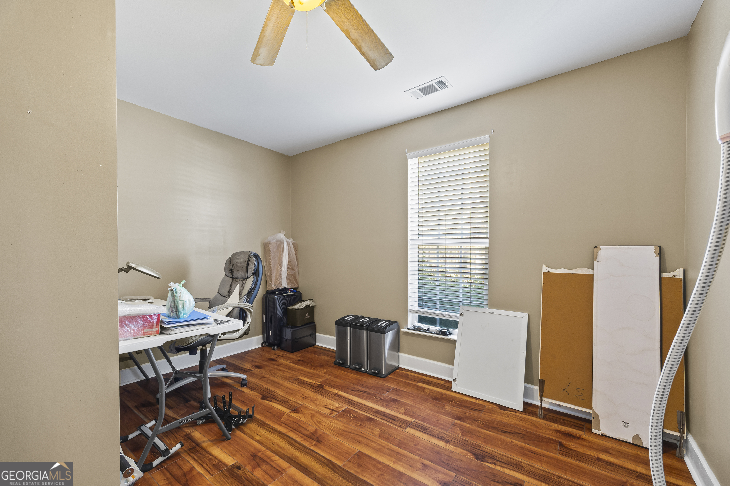 747 Washington Road Lexington, GA 30648 - Photo 37 of 118 a view of a workspace with furniture and a window
