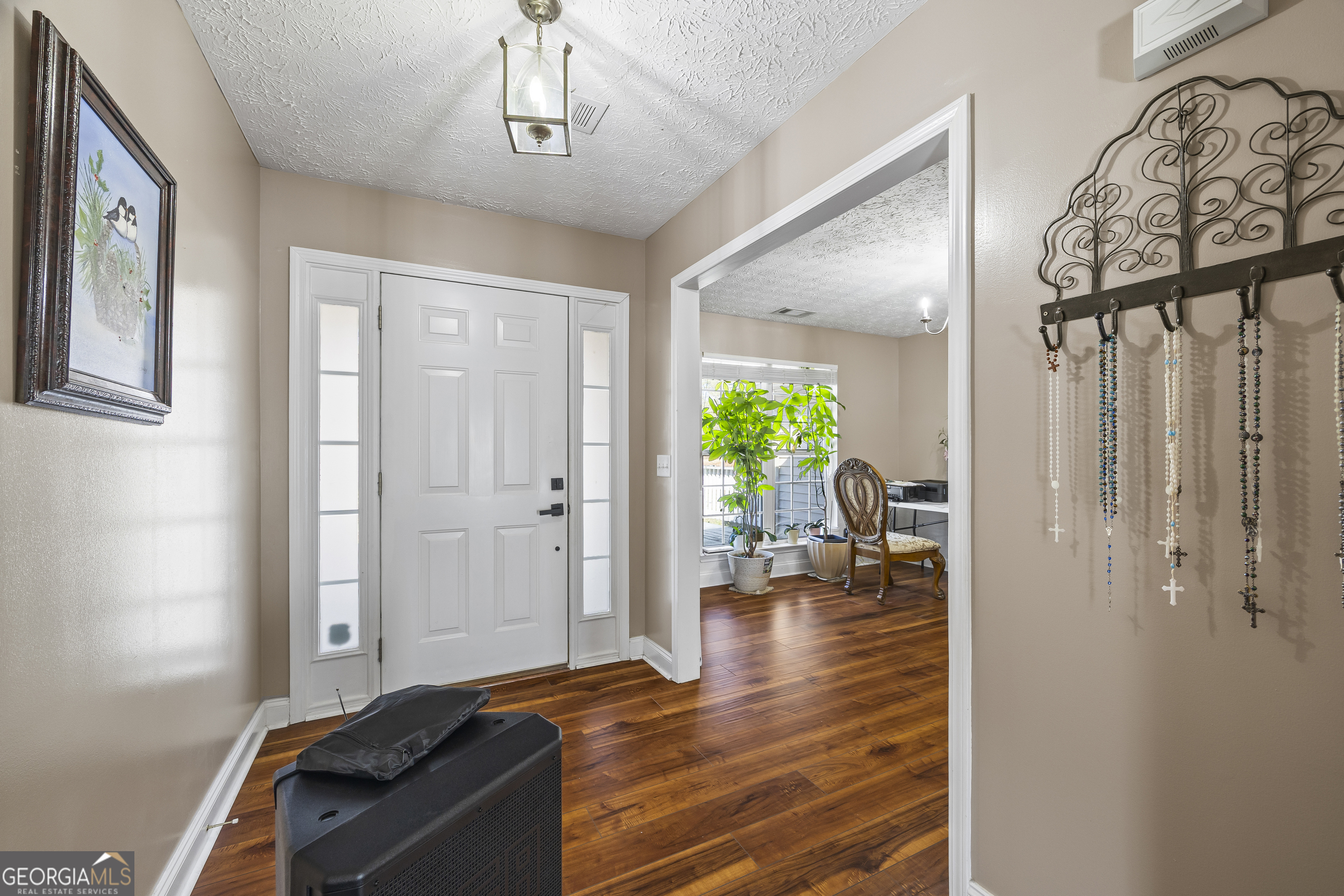747 Washington Road Lexington, GA 30648 - Photo 46 of 118 a view of a hallway with wooden floor and a livingroom with furniture
