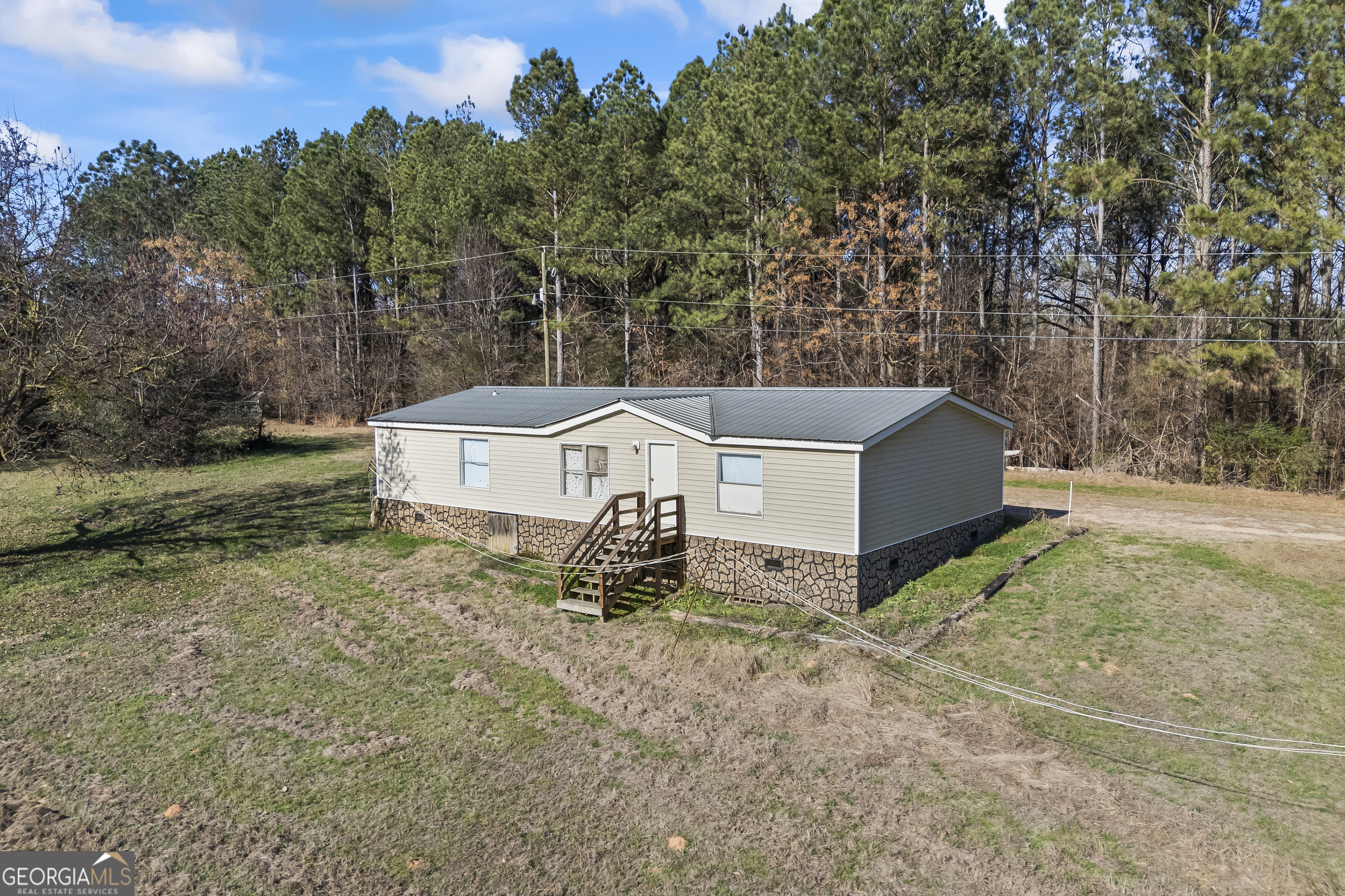 747 Washington Road Lexington, GA 30648 - Photo 66 of 118 a view of a barn in the middle of a yard
