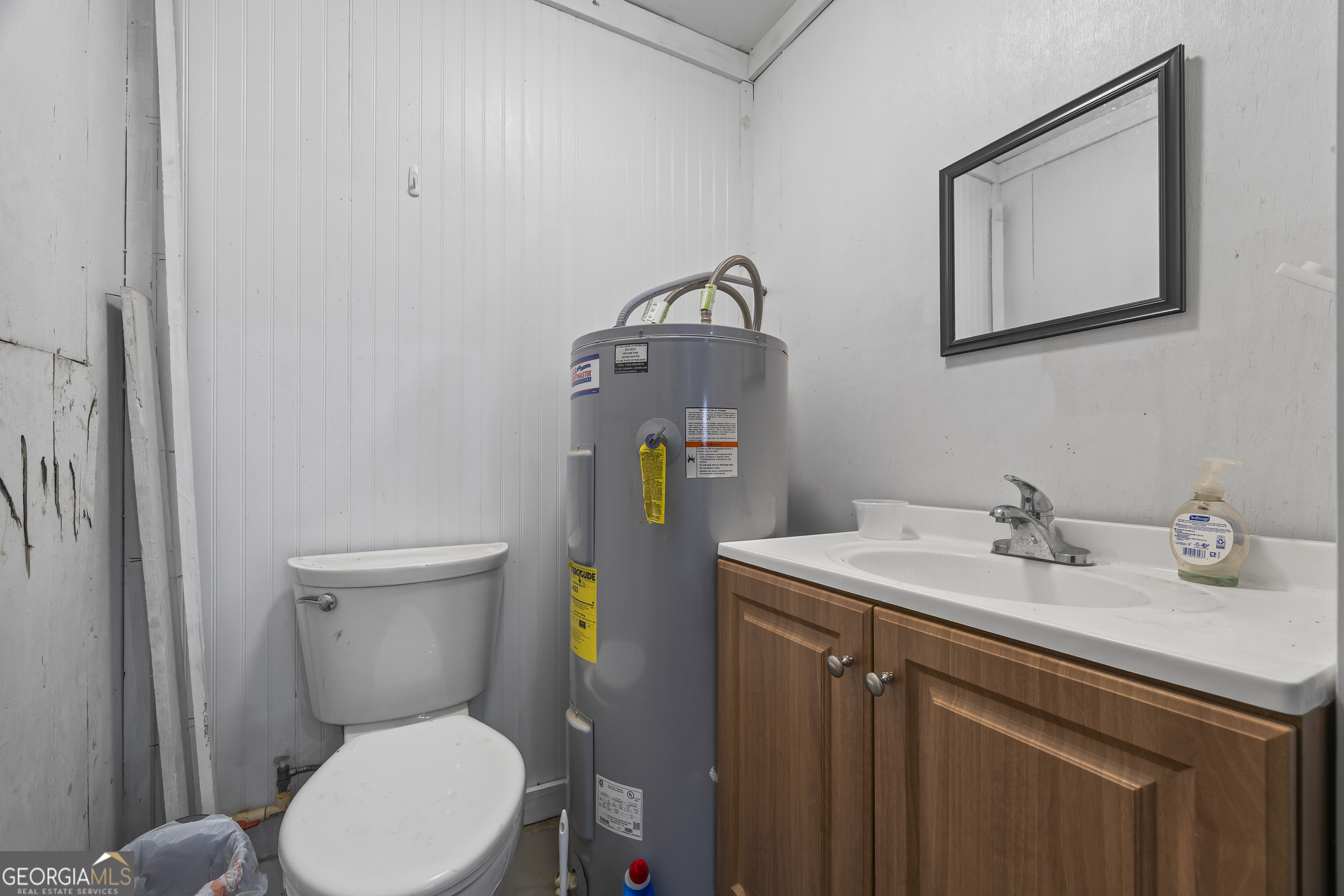 747 Washington Road Lexington, GA 30648 - Photo 99 of 118 a bathroom with a toilet sink and mirror