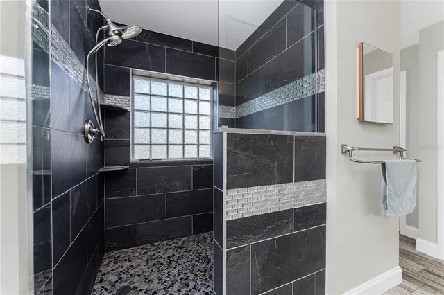 a view of a swimming pool with a lawn chairs under an umbrella