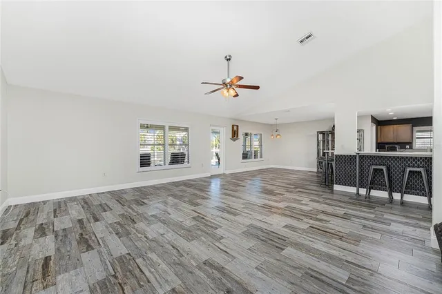 a view of a livingroom with furniture wooden floor and window