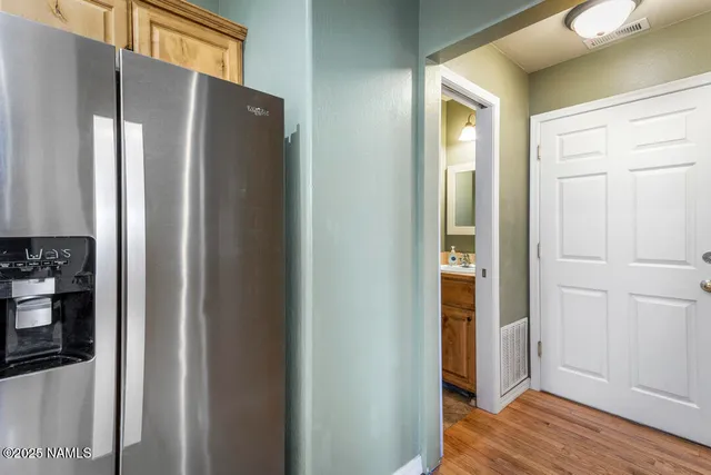 a view of a refrigerator in kitchen and wooden floor