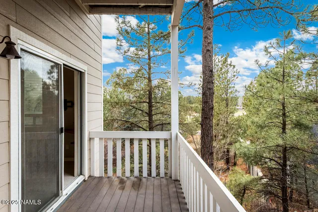 a view of a balcony with tree