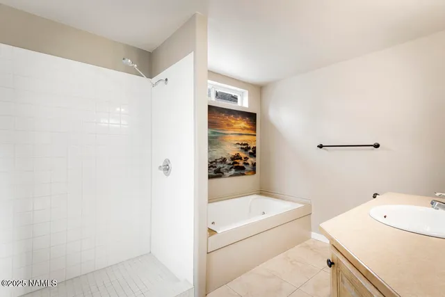 a bathroom with a bathtub and shower
