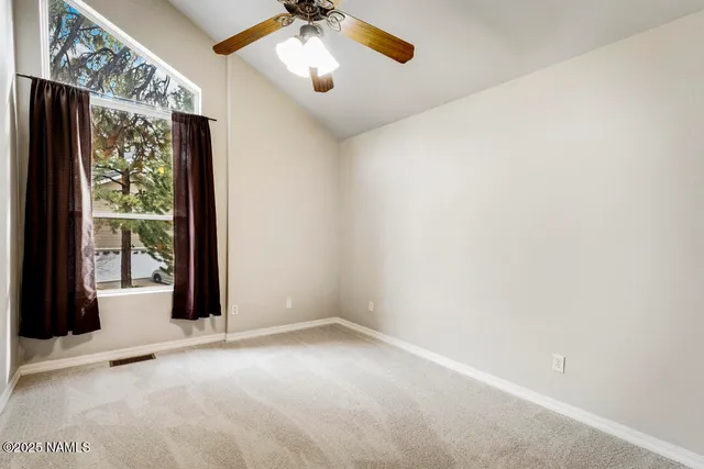 a view of a chandelier fan and refrigerator in a room