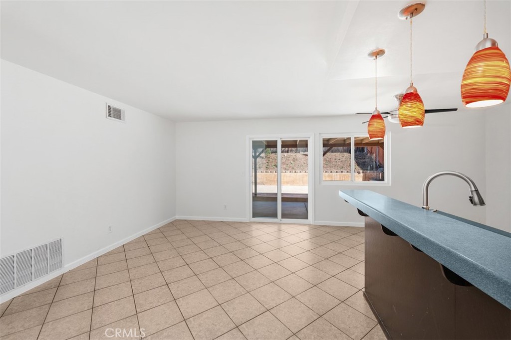 10424 2nd Street Santee, CA 92071 - Photo 13 of 28 Dining space opens nicely toward the kitchen and rear yard, creating a natural gathering area for daily meals or casual entertaining. Sliding glass doors bring in light and add indoor-outdoor appeal.