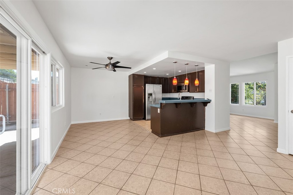 10424 2nd Street Santee, CA 92071 - Photo 14 of 28 Spacious main living area offers great natural light and a smooth transition into the kitchen, ideal for both relaxed evenings and hosting friends. The open design enhances the sense of space.