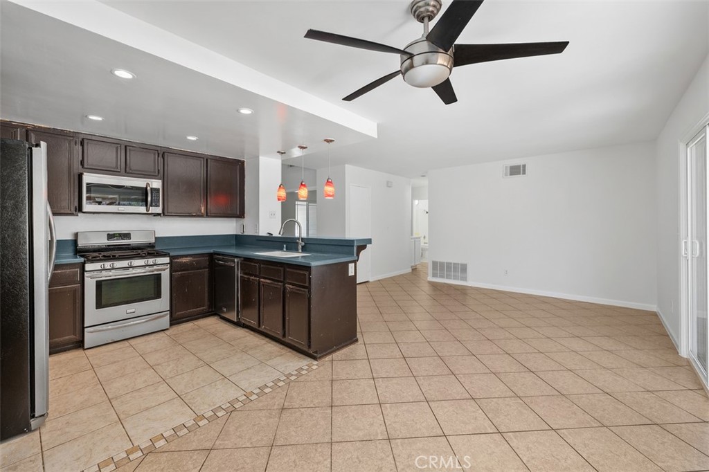 10424 2nd Street Santee, CA 92071 - Photo 16 of 28 Updated kitchen features dark cabinetry, stainless steel appliances, and a practical layout designed for everyday ease. Ample counter space supports both meal prep and entertaining.
