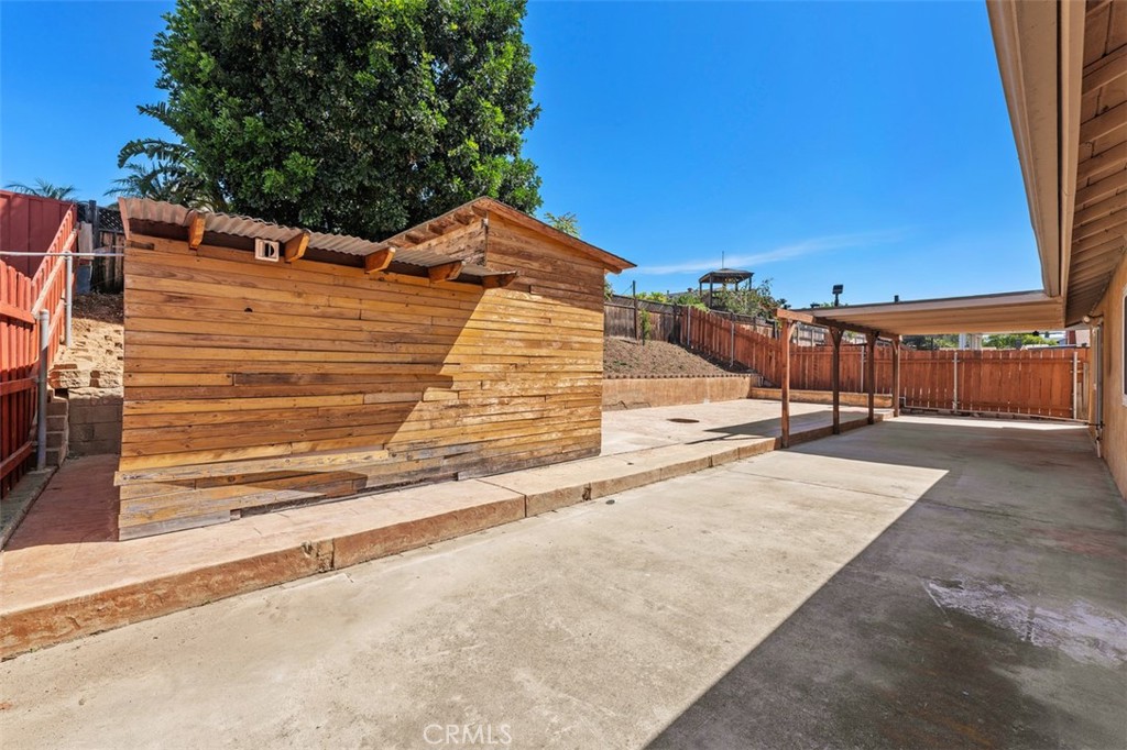 10424 2nd Street Santee, CA 92071 - Photo 27 of 28 Side yard and hardscape area provide extra outdoor functionality with clean lines and privacy fencing. This space is well suited for storage, pets, or everyday convenience.