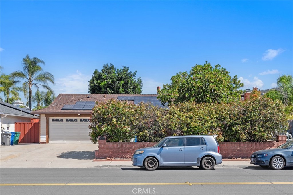 10424 2nd Street Santee, CA 92071 - Photo 3 of 28 The front elevation highlights the attached two-car garage and low-maintenance yard, creating a practical and polished first impression. Mature greenery adds warmth and character to the exterior.