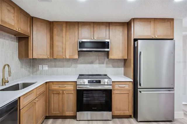 a kitchen with a refrigerator sink and microwave