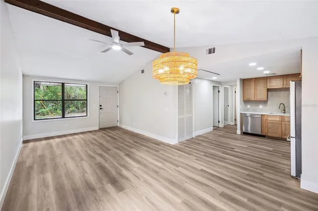 a view of a kitchen with a stove wooden floor and a window
