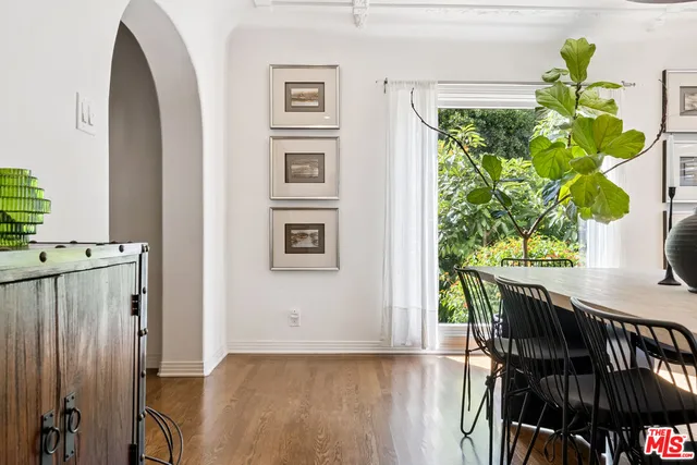 a view of a hallway with wooden floor and a potted plant