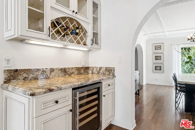 a kitchen with a stove and a wooden floor