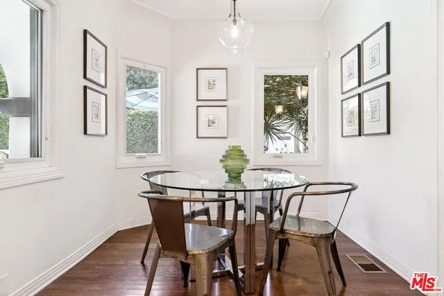a view of a dining room with furniture window and wooden floor