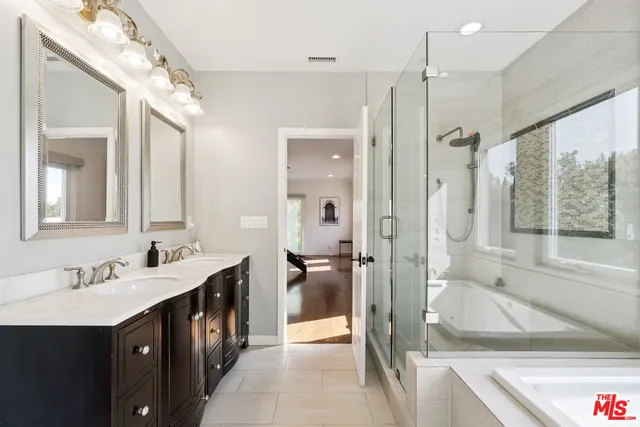 a white bath tub sitting next to a shower