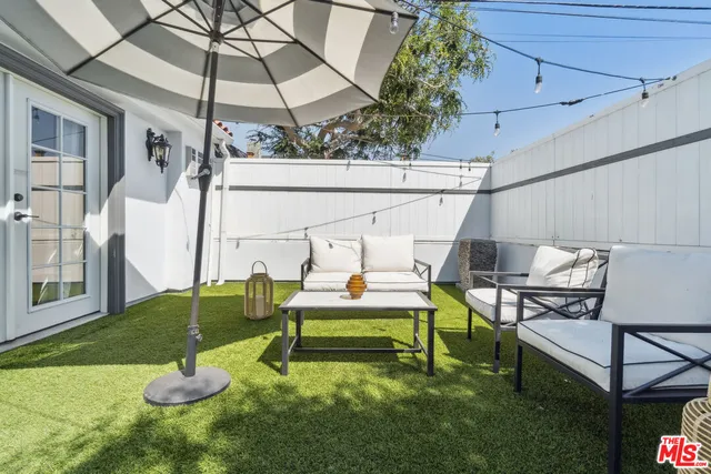 a view of a small house with a small yard