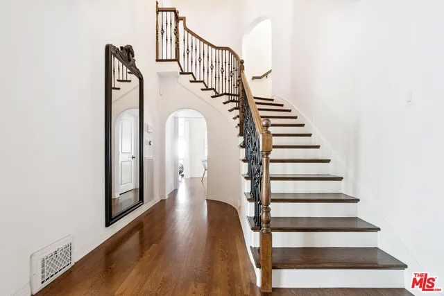 a view of entryway and hall with wooden floor