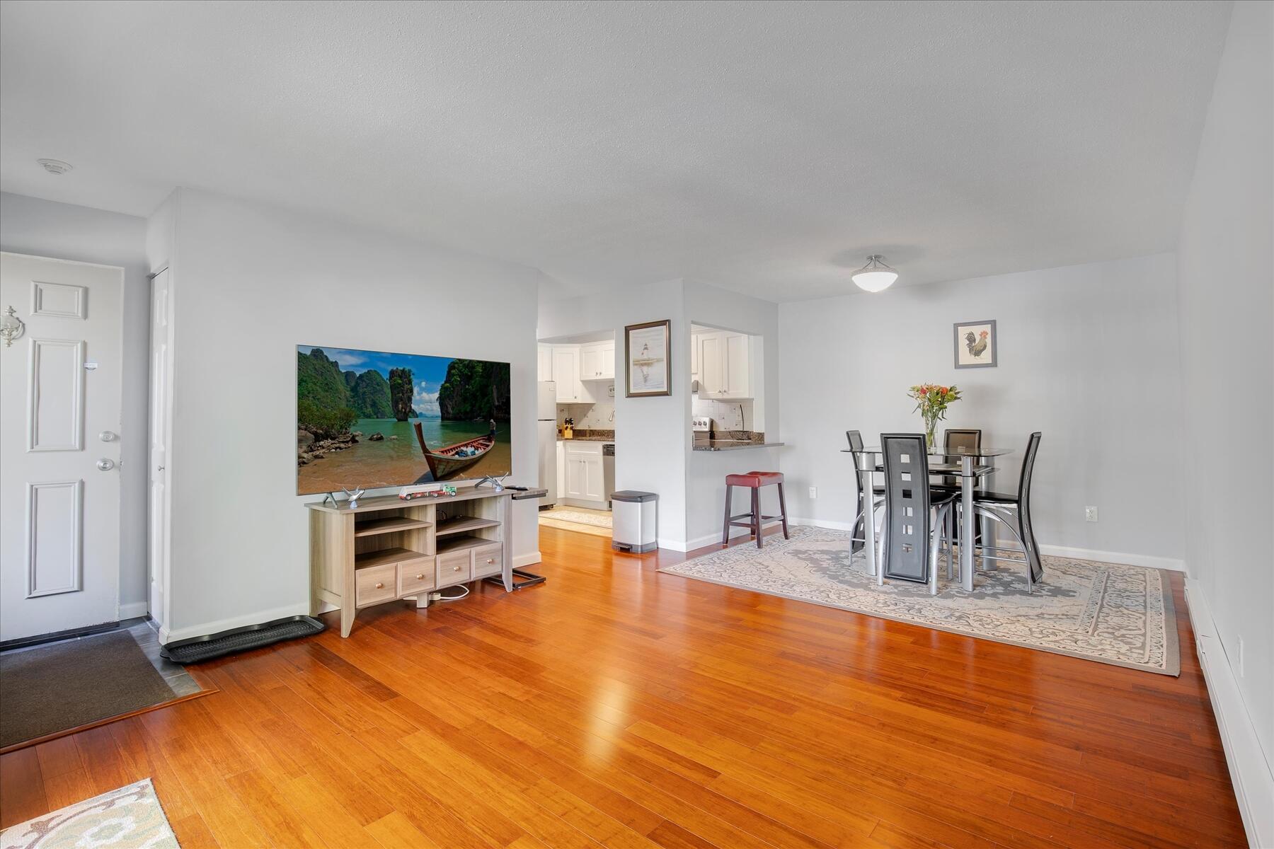 800 Bearses Way, Unit 1EB Hyannis, MA 02601 - Photo 9 of 37 a living room with furniture and a flat screen tv