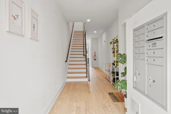 a view of entryway with furniture and wooden floor