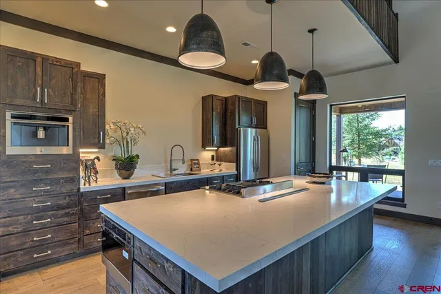 a kitchen with a stove a sink and a refrigerator