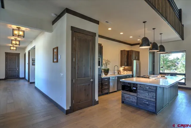 a large kitchen with stainless steel appliances granite countertop a refrigerator a oven and a large window